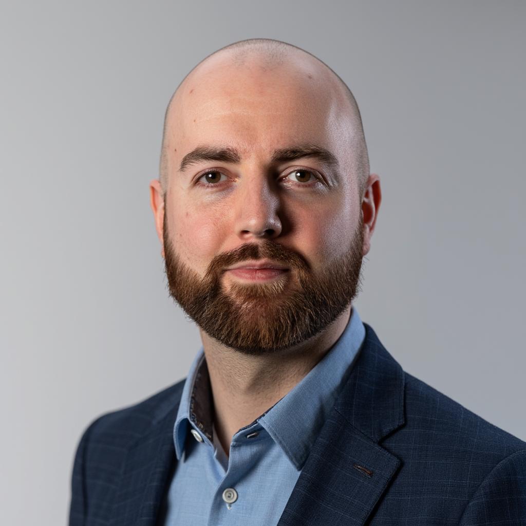 Portrait of Simon, technologist and entrepreneur, wearing a suit jacket and shirt